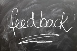 This is the image of blackboard that says in white chalk "feedback," The image supports our executive coaching firm's blog post about gathering internal 360 feedback thru an assessment tool.